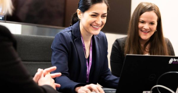 Women looking at a laptop and smiling