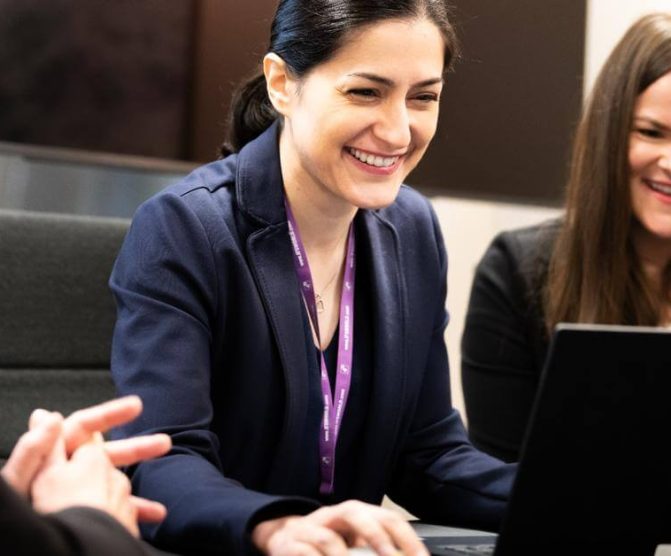 Women looking at a laptop and smiling