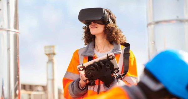 Women with a tablet using augmented reality on a construction side